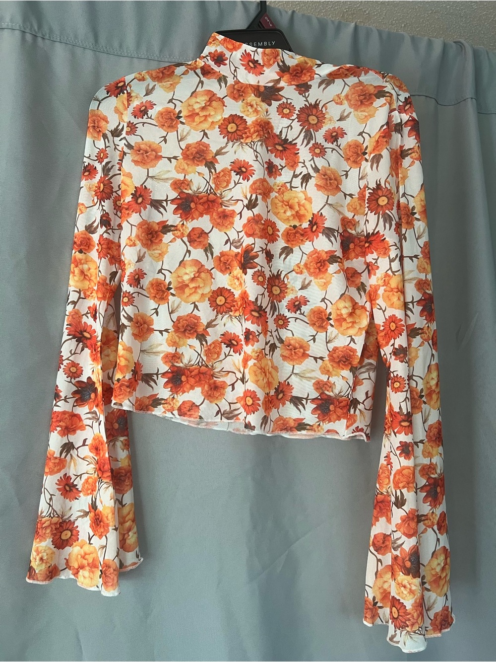 Mock Neck Floral Crop Top in Orange - Assembly Label